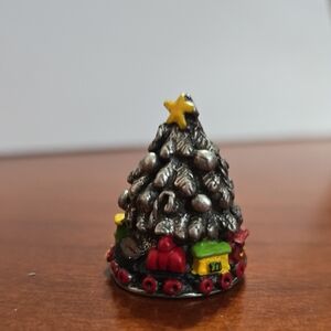 Thimble Christmas Tree star topper and a toy train circling the base. Pewter